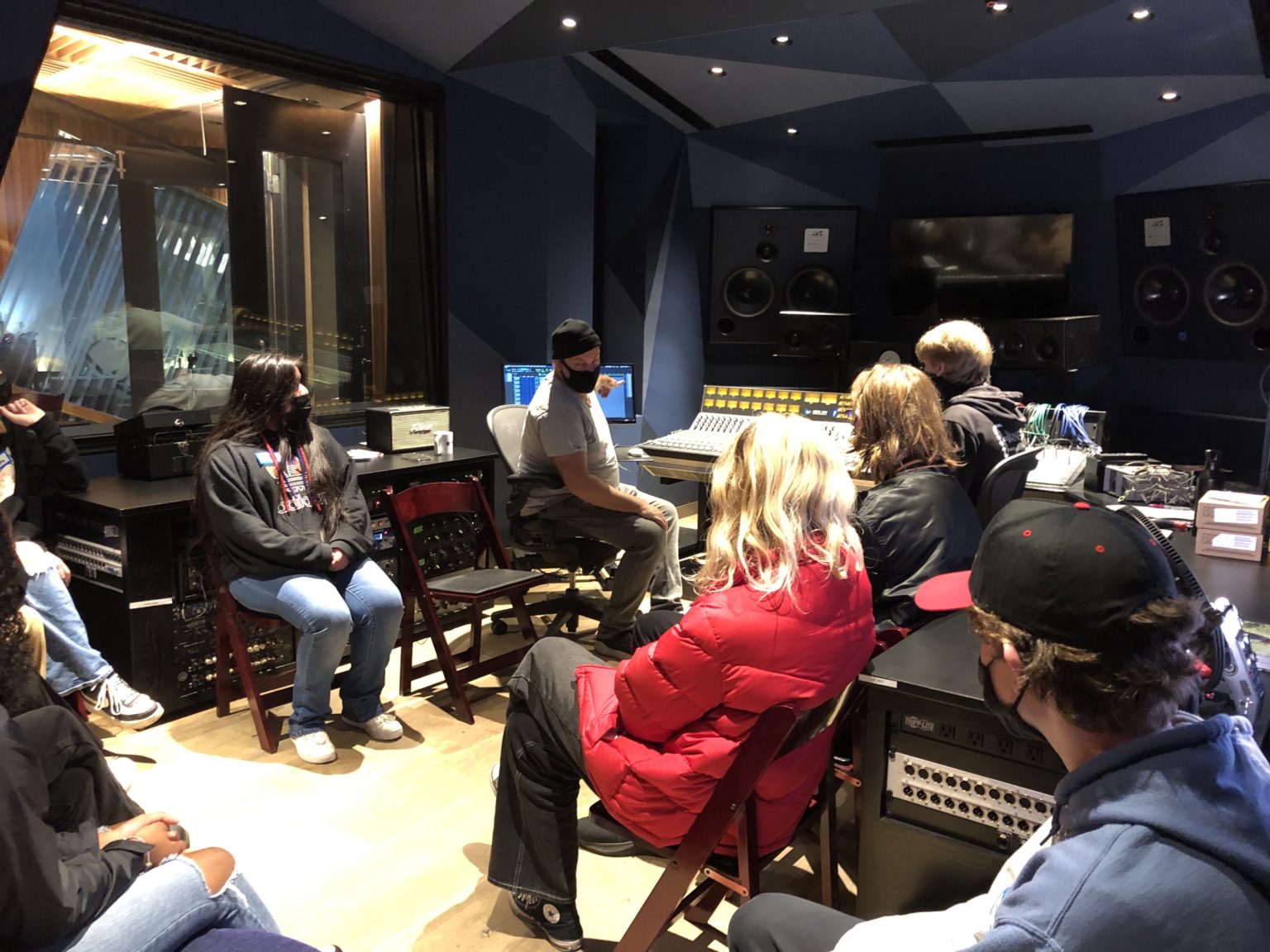 Students and their teacher in a recording studio
