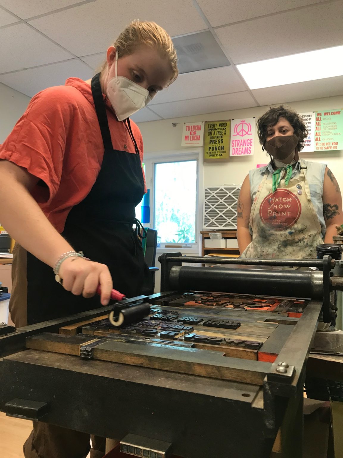 Instructor using letter press while student watches