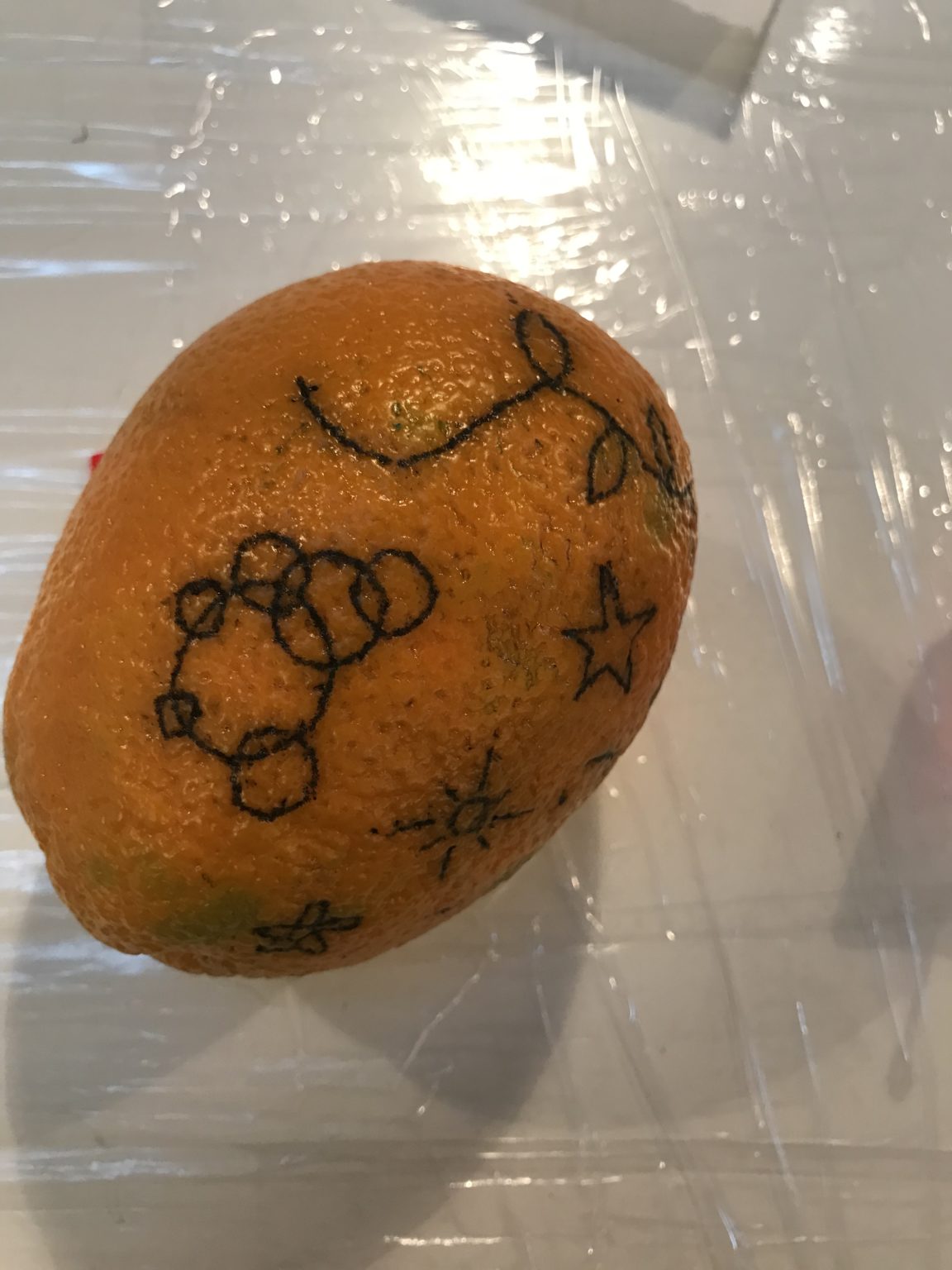 Tattooed artwork on an orange